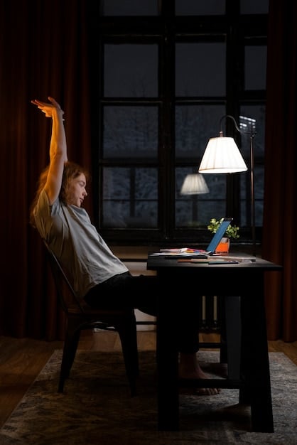 A person closing their laptop at the end of the workday in a designated home office area, signaling the end of work and the beginning of personal time. Soft, warm lighting sets a relaxing mood.