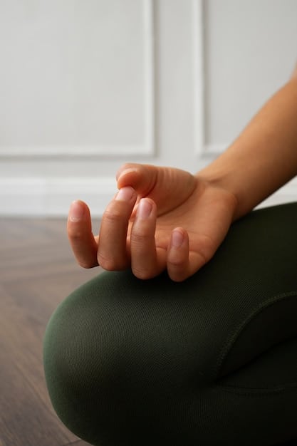 A close-up shot of a person's hands gently resting in their lap while meditating, symbolizing the physical relaxation and mental awareness cultivated through mindfulness practice.