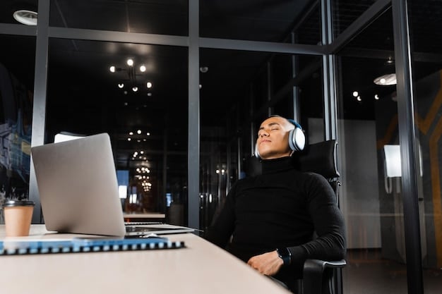 A person wearing noise-canceling headphones while working on a laptop in a modern, minimalist office space. Soft, ambient lighting and a blurred background emphasize focus and concentration.