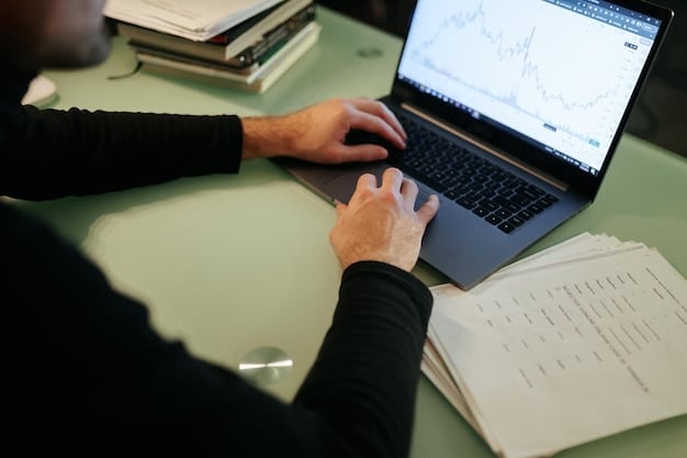A close-up of a US professional using a project management software on their laptop, showcasing task assignments, deadlines, and progress tracking.
